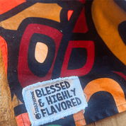 Close-up of the Blessed & Highly Flavored tag on the vibrant multicolor Aravella Apron from Black-owned brand soulPhoodie