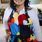 Model wearing Beryl Apron by Black-owned brand soulPhoodie with bold abstract multicolor pattern