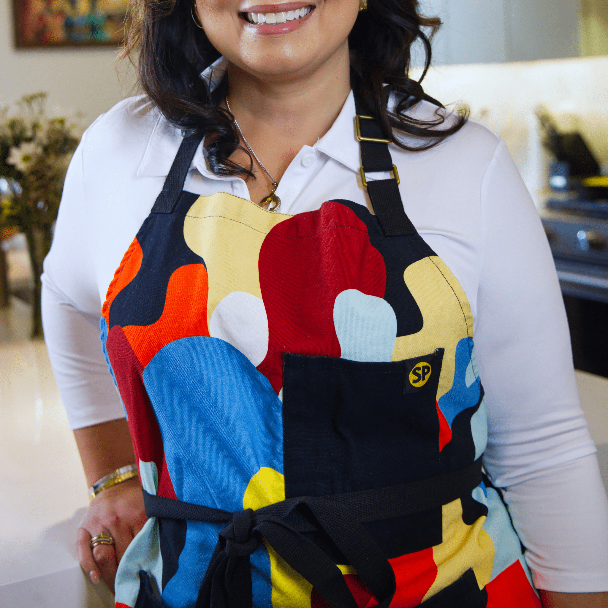 Model wearing Beryl Apron by Black-owned brand soulPhoodie with bold abstract multicolor pattern
