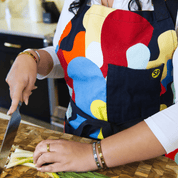 Chef cutting vegetables while wearing colorful Beryl Apron from Black-owned brand soulPhoodie